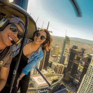 Young couple enjoy helicopter tour over Downtown