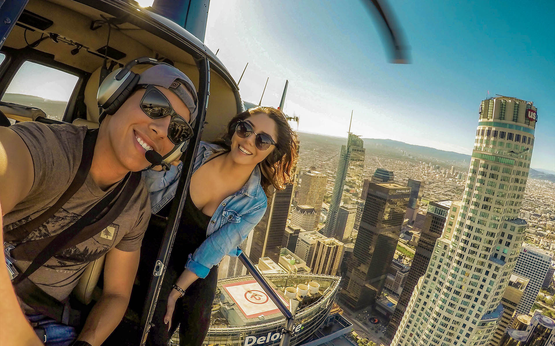 Young couple enjoy helicopter tour over Downtown